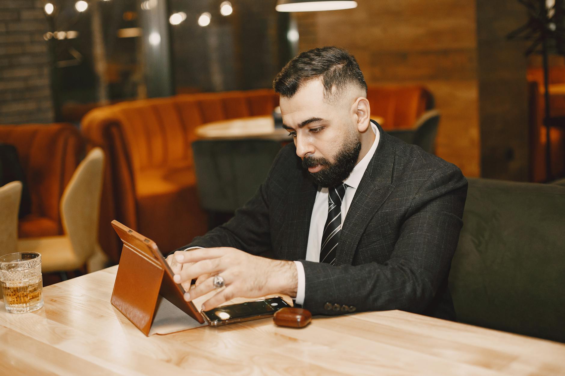 A buyer scrolling through a product spec sheet on a tablet, appearing informed but unmoved, no action taken