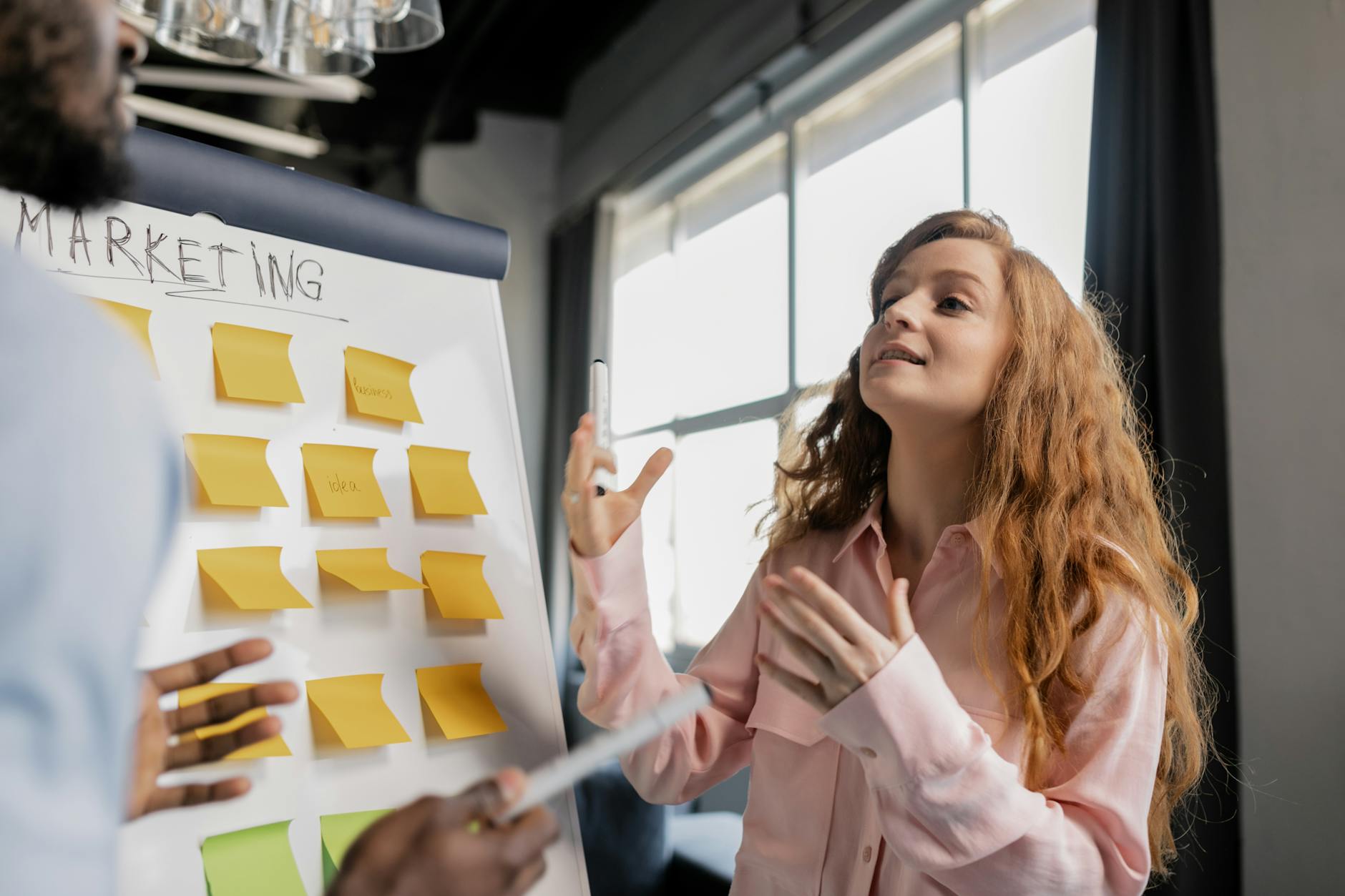 A sales manager reviewing a simple CRM spreadsheet, connecting content touchpoints to meeting conversions with sticky notes