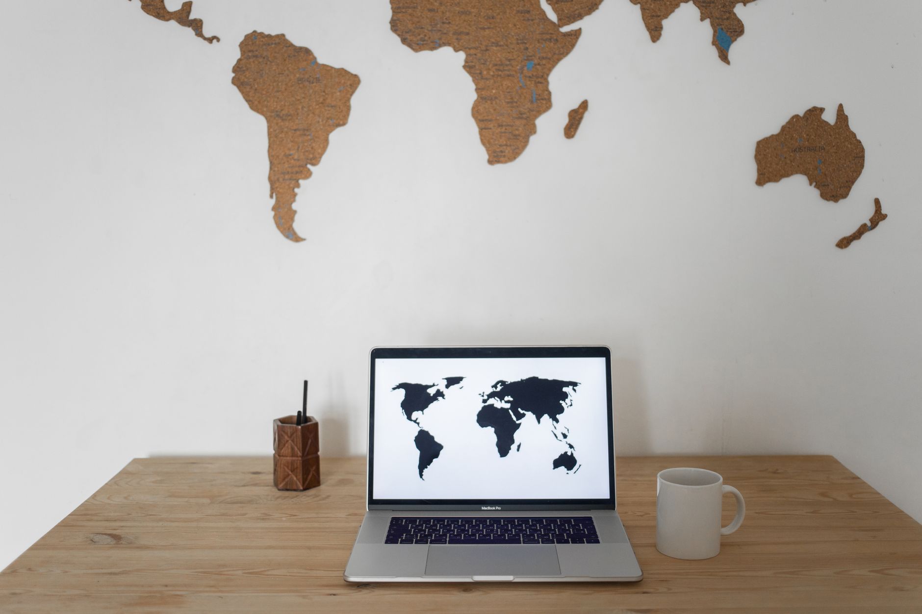 A high-tech workspace displaying a clean dashboard on a monitor with world map and search metrics, illuminated by soft blue light.