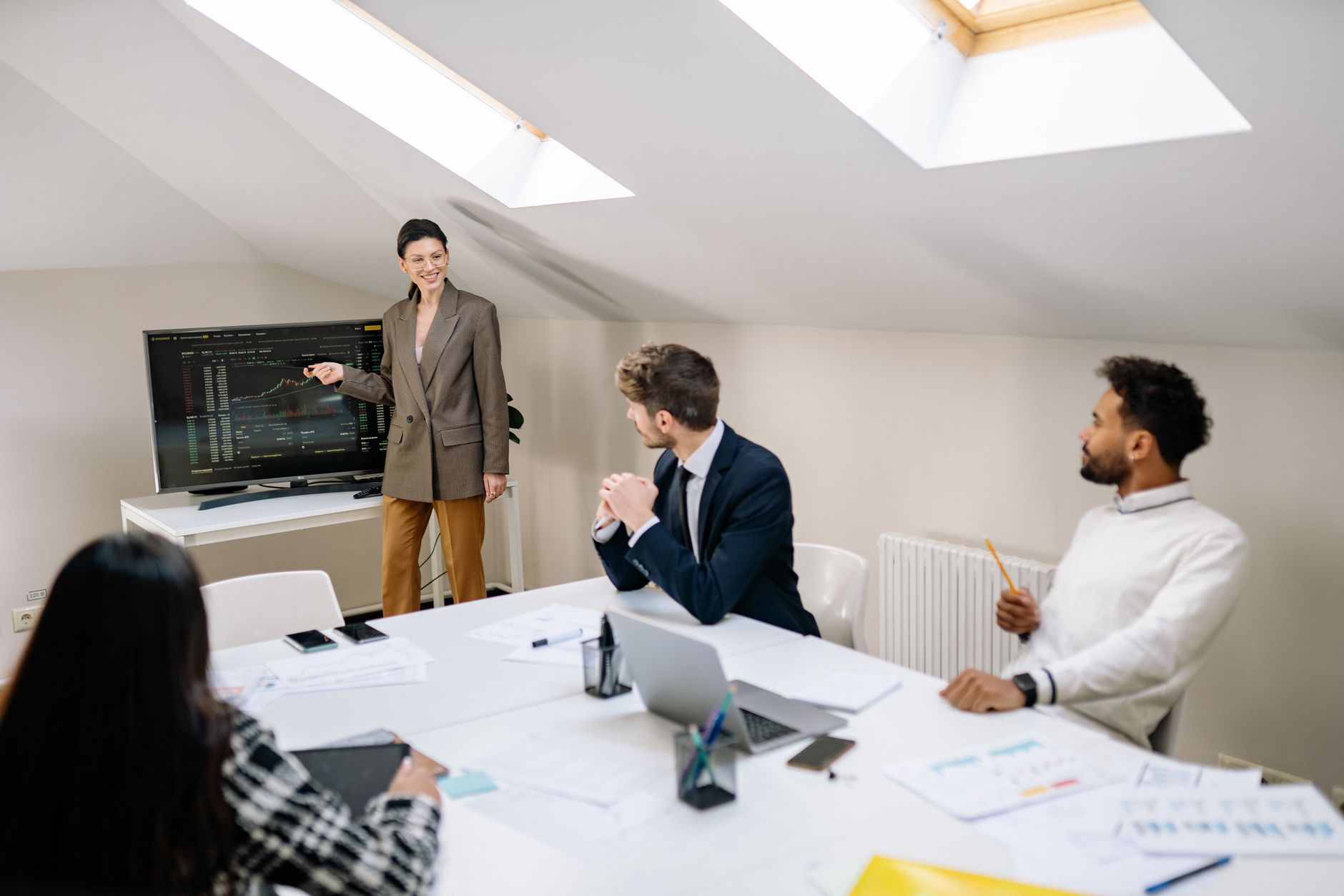 A team of diverse marketing professionals analyzing complex localized campaign data on a large screen in a modern office, realistic style