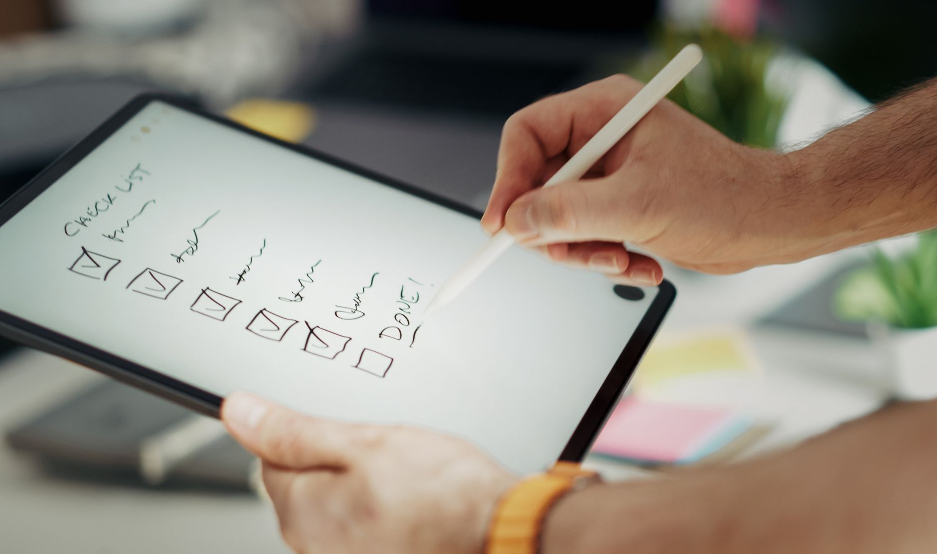 A checklist on a tablet screen with items like 'Edge Server Check', 'Network Simulation Test', and 'Asset Compression' ticked green, held by a developer.