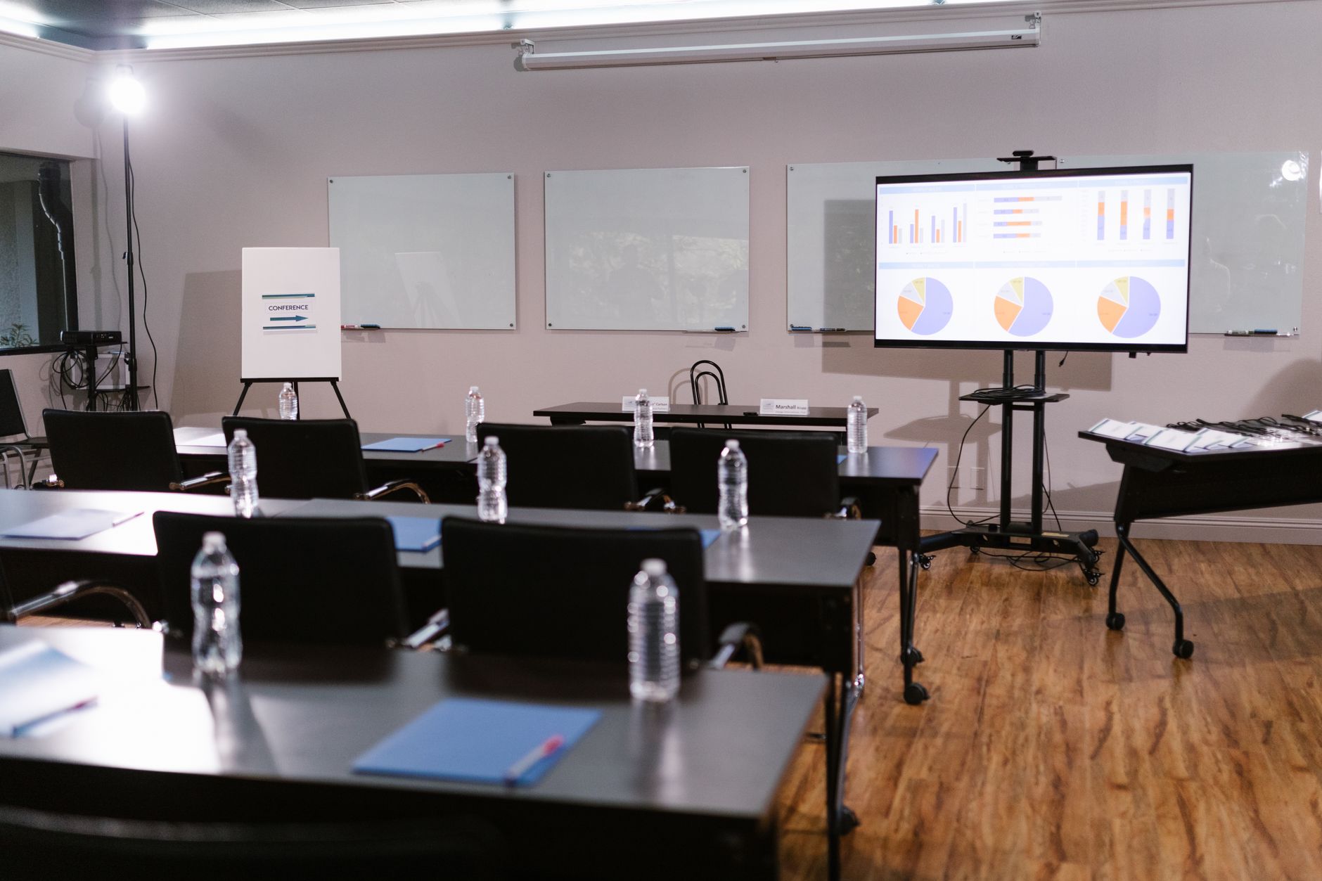 A clean, minimal office meeting room where a professional team looks at a projected slide showing global organic search traffic distribution map.