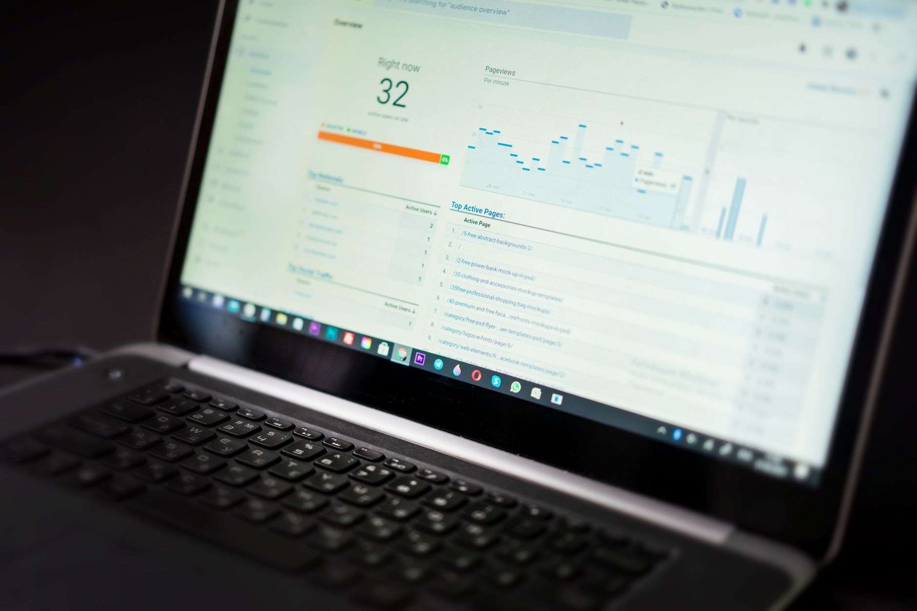 A close-up shot of a modern laptop screen showing a business data validation dashboard with green checkmarks and yellow warning icons next to company names.