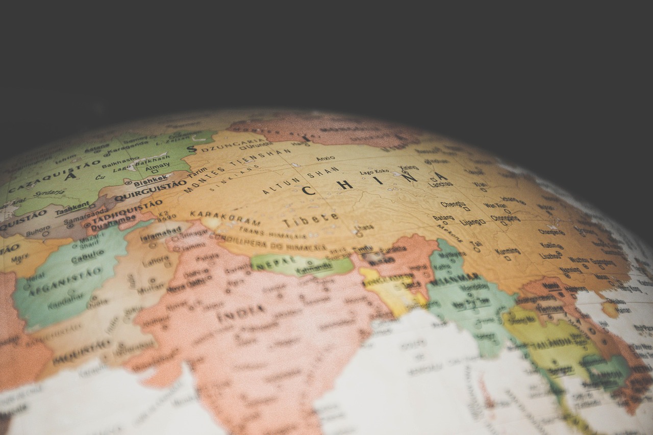 A world map split into two zones with subtle digital borders, representing geopolitical AI division