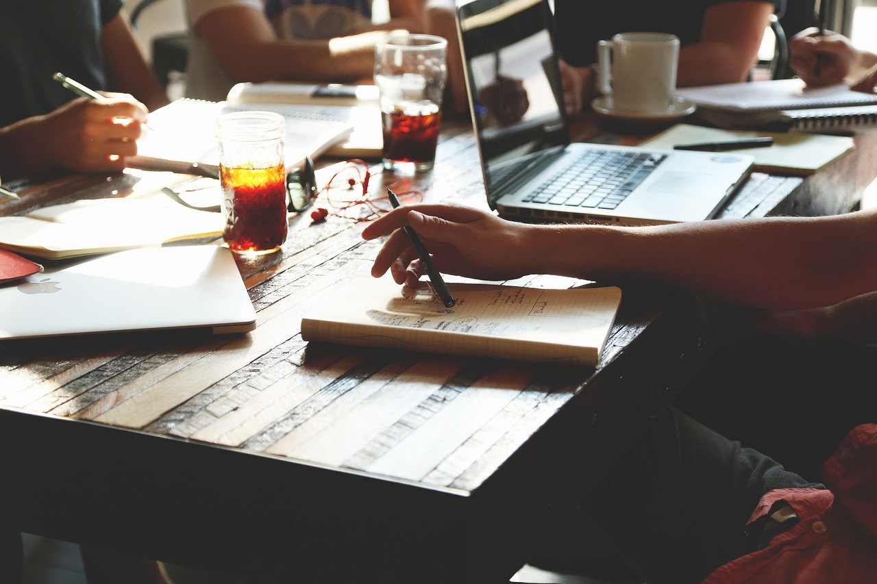 A small startup team in a bright Korean office, focused and collaborative, working on a product roadmap